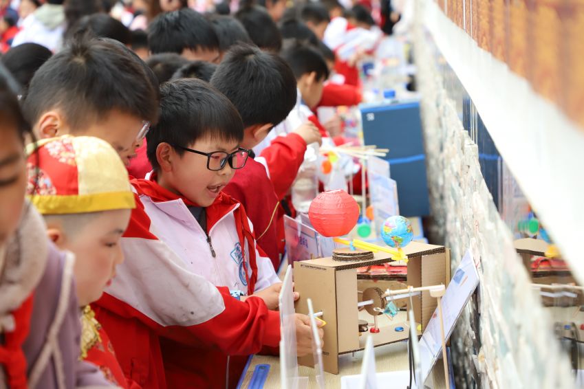 4月30日，<a href=//www.hp-dv.com target=_blank class=infotextkey>毕节</a>二十二小学生在操场上参观、体验科技品展览。（苏苇摄）1